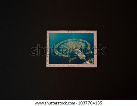 Souvenir - Fridge magnet from Dubai, Emirates on black background