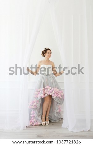 A beautiful bride is standing and looking