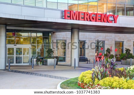 Red and white emergency room sign outdoors at hospital