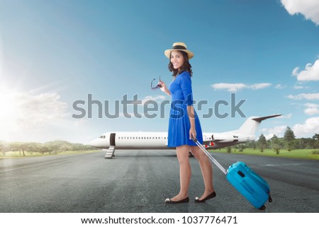 Attractive asian woman going vacation with airplane over blue sky background