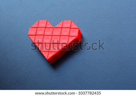 The red mosaic heart set on the dark background for telling love to someone.