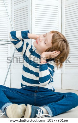 boy in stylish clothes posing in the Studio