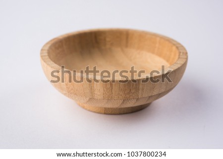 Empty wooden bowl or decorative wooden plate, isolated over white background