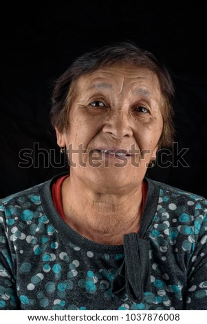 portrait of a happy elderly woman on a black background