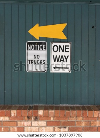 A cluster of signs on a wall in Juneau, Alaska informs or confuses drivers.
