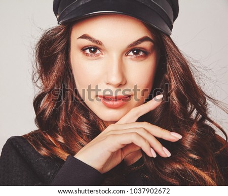Portrait of young stylish laughing girl model in black casual summer clothes in cap with natural makeup isolated on gray background. Looking at camera