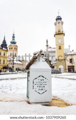 Lantern with inscription - do what you love everyday. SNP square in Banska Bystrica, Slovak republic. Winter scene. Travel destination.