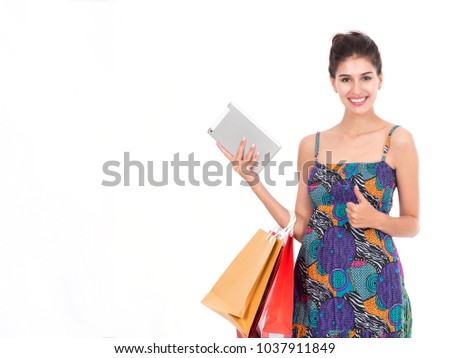 Picture showing pretty woman shopping online with smart tablet.Portrait of young happy smiling woman with shopping bags.