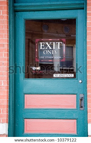 Blue and pink door with exit only sign