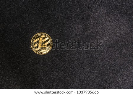 golden litecoin lie on dark abstract background