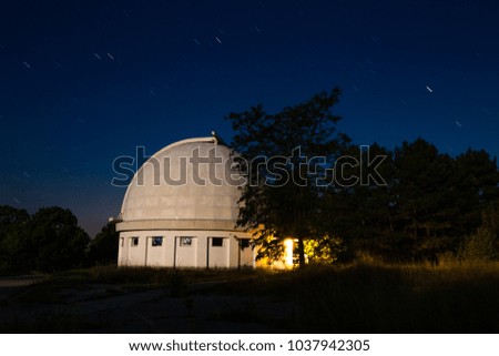 Observatory at night with stars.