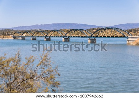 Railway bridge with arches over river in portuguese landscape