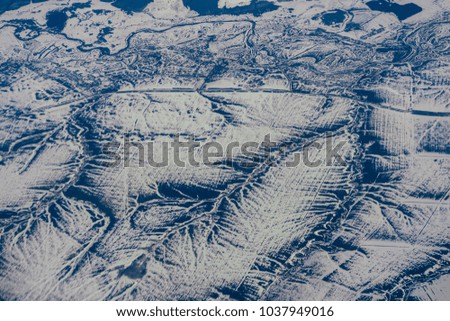 aerial photography from the height of the aircraft mountains in the snow in winter in Siberia in Russia
