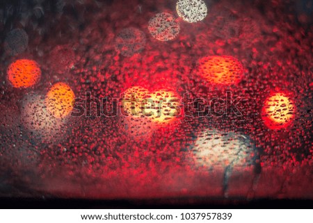 Rainy night background on glass