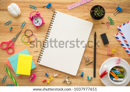 Flat lay of blank notebook and office supplies on wooden desk workplace background - Business and education creativity ideas concepts