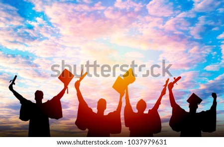 Silhouette of Student Graduation. They are seeing sunset. They are standing and show hand.Photo concept Silhouette and Success.