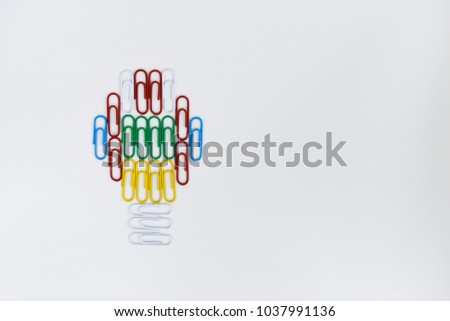 Colorful paper clip put on the white screen as the light bulb for idea concept