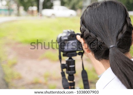 Girl learning to use a camera