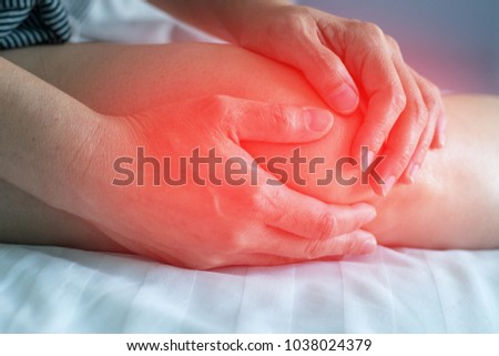 Knee pain disease concept. Hands on leg as hurt from Arthritis, gout or infections. Royalty-Free Stock Photo #1038024379