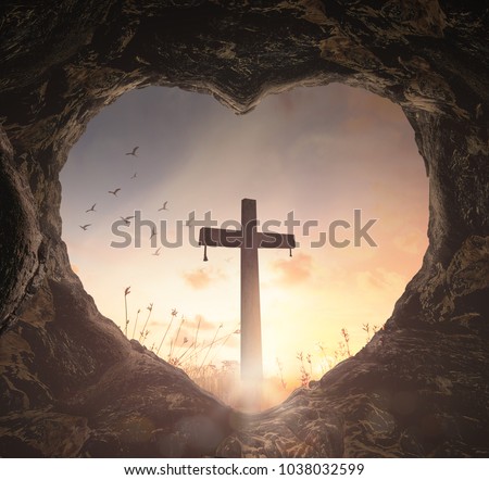 Good Friday concept: Heart shape of empty tomb stone with the cross over meadow sunrise background Royalty-Free Stock Photo #1038032599
