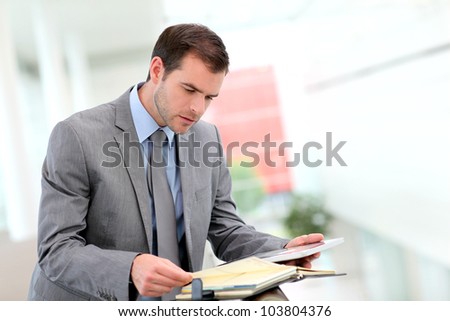 Businessman looking at meeting dates on agenda