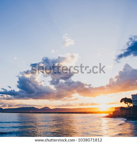 Calming scenic sunset at the sea with mountain views, Spain