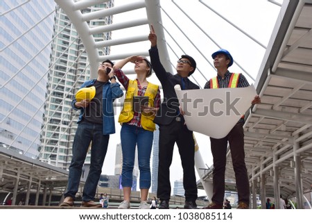 Engineer  Manager and one engineer man with one engineer woman with boss  Meeting  working Team building  Success holding Blueprint outdoors in construction site