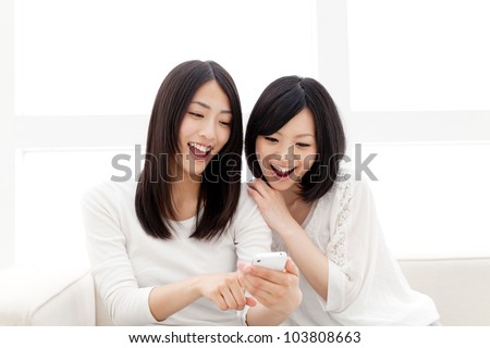 Beautiful young women using a moblie phone. Portrait of asian. Royalty-Free Stock Photo #103808663
