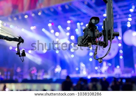 video camera on crane  covering event on stage