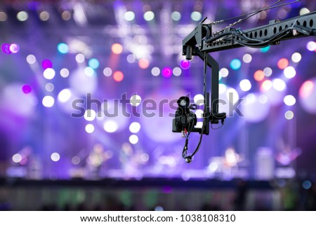 video camera on crane  covering event on stage Royalty-Free Stock Photo #1038108310