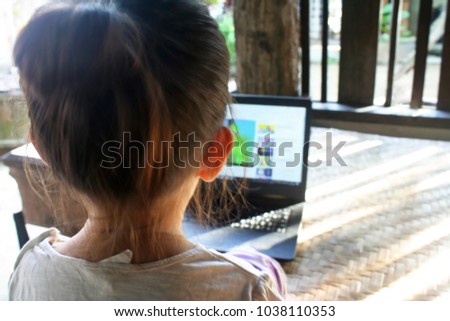 Little asian  child  watching laptop