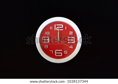 White and red clock at 12 o'clock On a black background Royalty-Free Stock Photo #1038137344