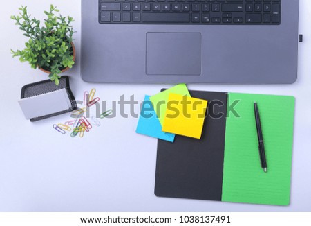 Close-up of comfortable working place in office with laptop, notebook, glasses, pen and other equipment laying on table with copy space. Top view.