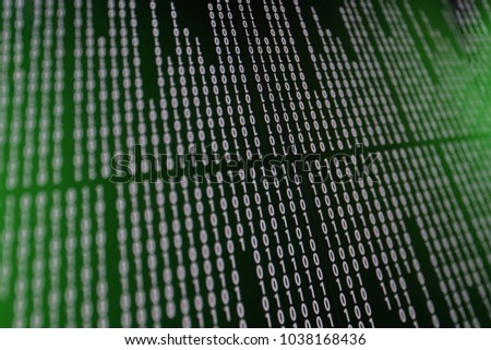 Digital Binary data and streaming binary code on computer screen metric background.Close up shallow center DOF with green light.