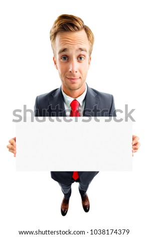 Full body portrait of funny young businessman in confident suit and red tie, showing blank signboard with copyspace area for advertising text or slogan, top angle view shot, isolated over white.