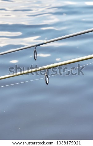 Close up picture of two fishing rods guides, shallow depth of field.
