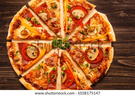 Pizza with salami, mushrooms and vegetables
