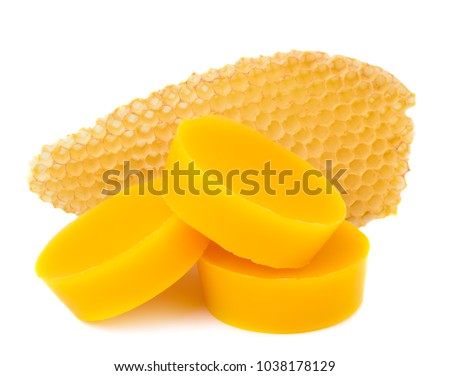 Pieces of natural beeswax and a piece of honey cell are isolated on a white background. Beekeeping products. Apitherapy Royalty-Free Stock Photo #1038178129