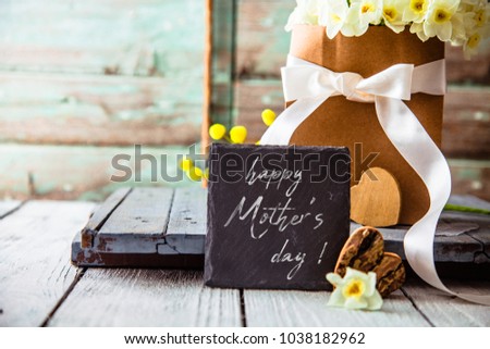 Easter eggs on wood. Colorful Easter holiday concept with  eggs in wisker basket in nature