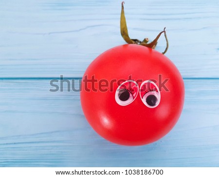 tomato funny cartoon on blue wooden