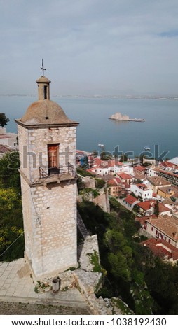 Aerial drone photo from picturesque and famous clock tower in fortress of Acronafplia with views to iconic city of Nafplio and Bourtzi, Argolida, Peloponnese 
