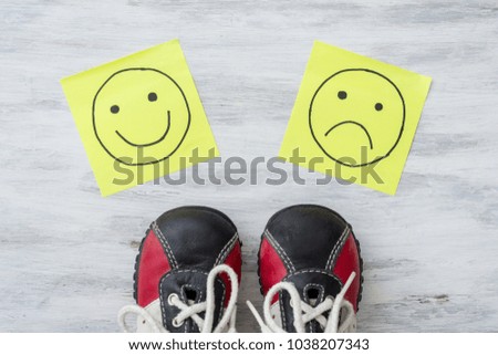Sneakers, choice, hand drawing unhappy and happy smileys.