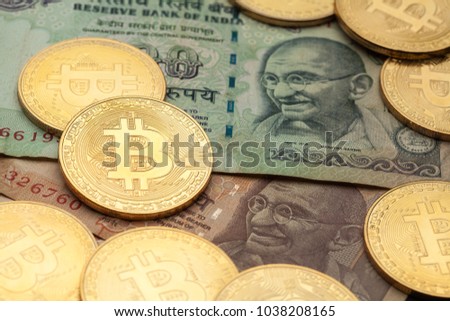 Bitcoin cryptocurrency with Indian rupee banknotes