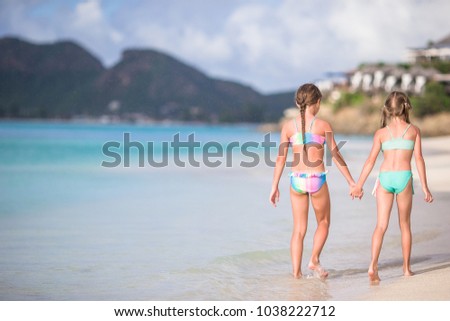 Adorable little sisters at beach during summer vacation