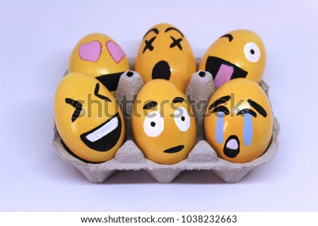 Emoticons Easter Eggs on egg-cup and white background.