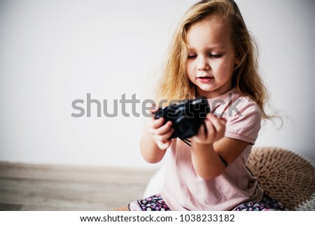 portrait of a little girl with a camera