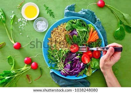Buddha bowl healthy vegan meal with kale, quinoa, various green sprouts and season greens, clean eating concept, view from above, flat lay Royalty-Free Stock Photo #1038248080
