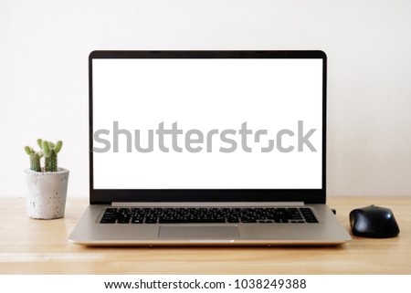 laptop on  wood table and cactus