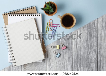 Notebook with a spring on a colored background with paper clips. top view
