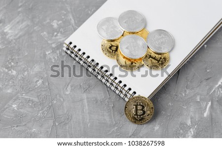 bitcoin on a notebook, coin bitcoin on a table, a lot of free space